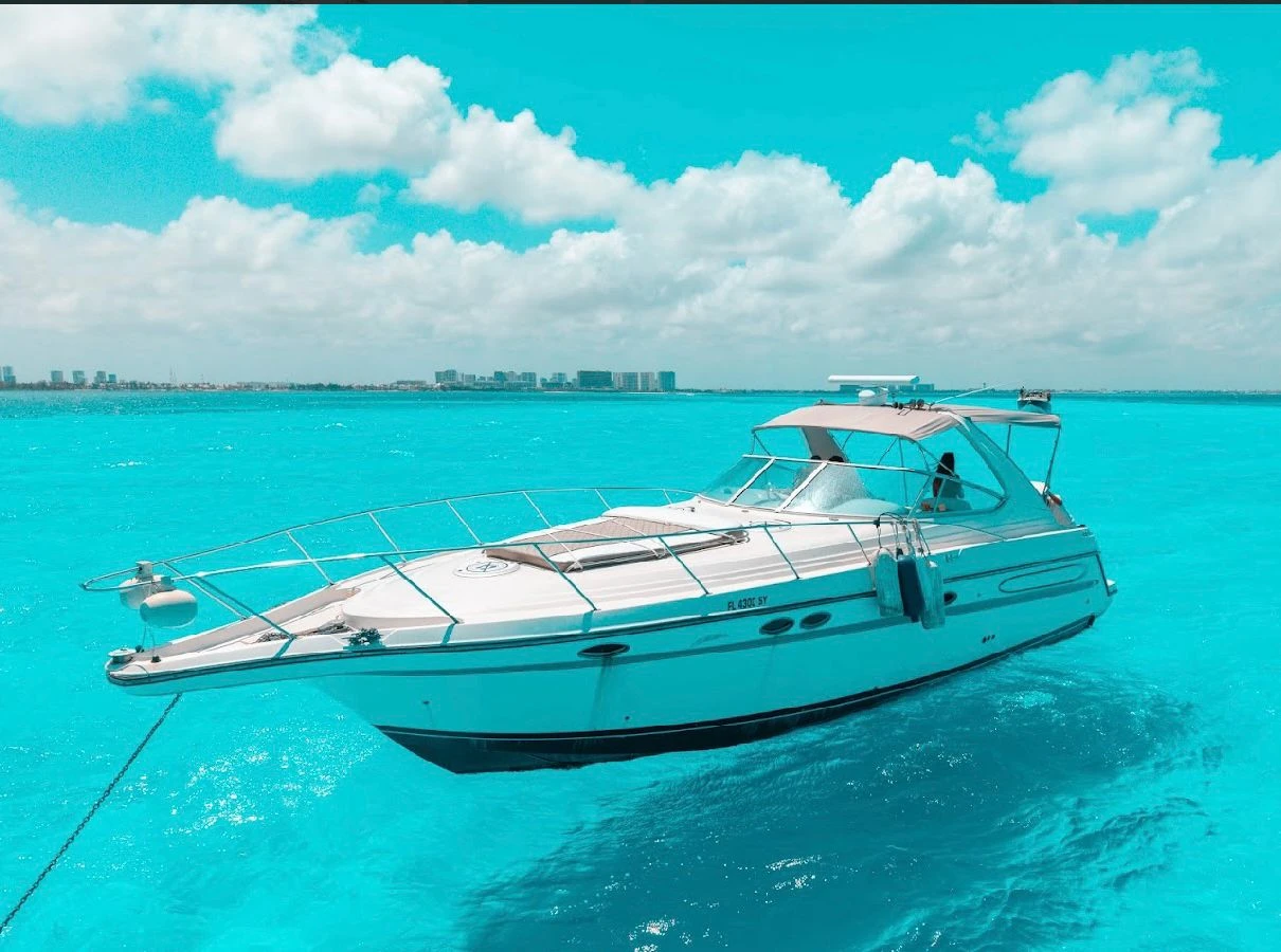 Yacht side profile with Cancún skyline